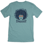 Spikeodelic volleyball men's t-shirt in dusty blue. Back graphic is man's face with afro made from volleyballs and players spiking volleyballs. Man's glasses are round and feature volleyballs. The words "Spikeodelic" are below the graphic. The majority of