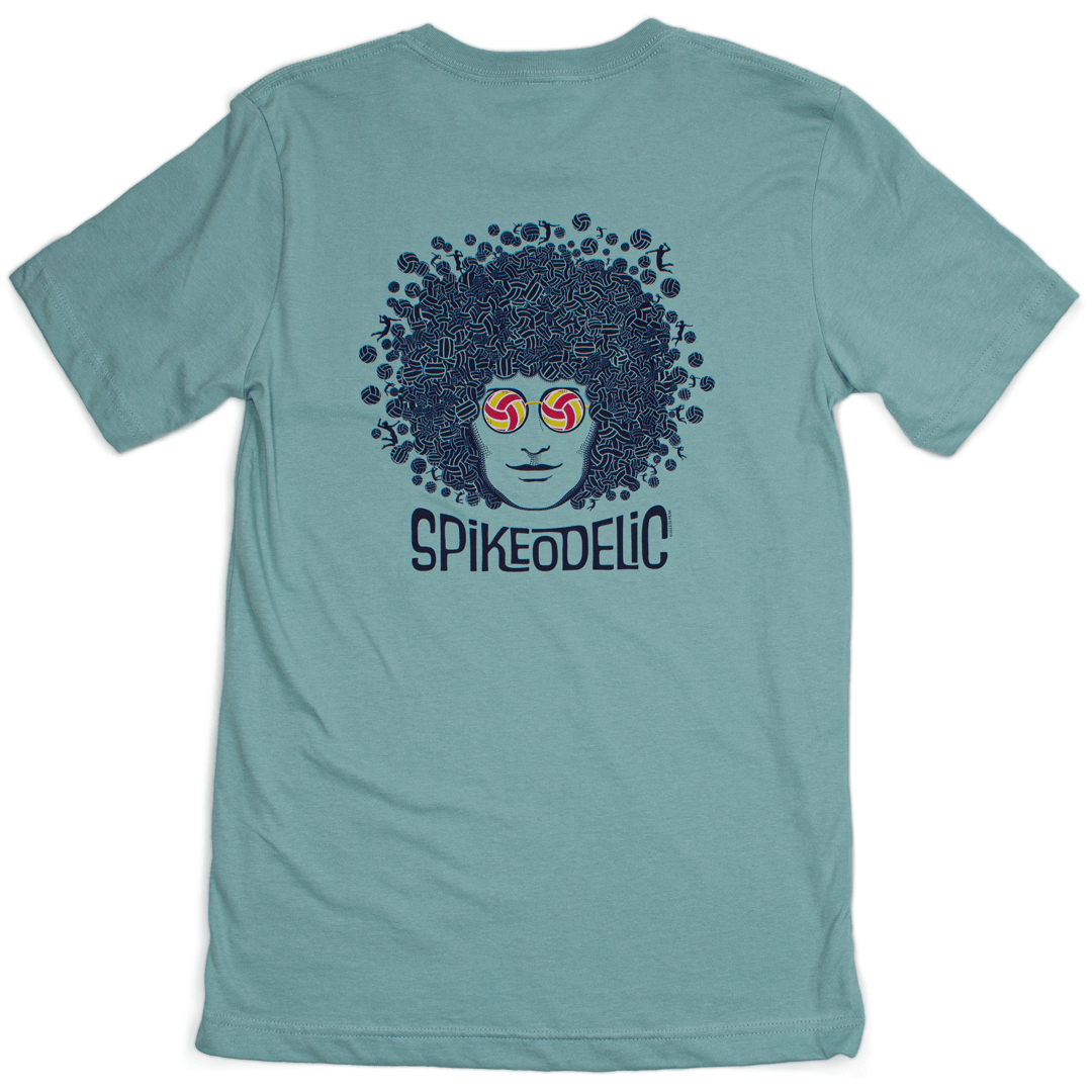 Spikeodelic volleyball men's t-shirt in dusty blue. Back graphic is man's face with afro made from volleyballs and players spiking volleyballs. Man's glasses are round and feature volleyballs. The words "Spikeodelic" are below the graphic. The majority of