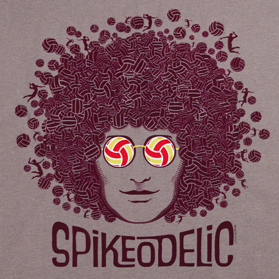 Spikeodelic volleyball men's t-shirt detail of art on pebble tee. Back graphic is man's face with afro made from volleyballs and players spiking volleyballs. Man's glasses are round and feature volleyballs. The words "Spikeodelic" are below the graphic. T