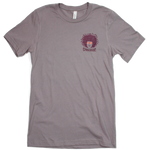 Spikeodelic volleyball men's t-shirt in pebble. Front pocket graphic is man's face with afro made from volleyballs and players spiking volleyballs. Man's glasses are round and feature volleyballs. The words "Spikeodelic" are below the graphic. The majorit